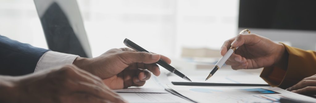 two people pointing to a document