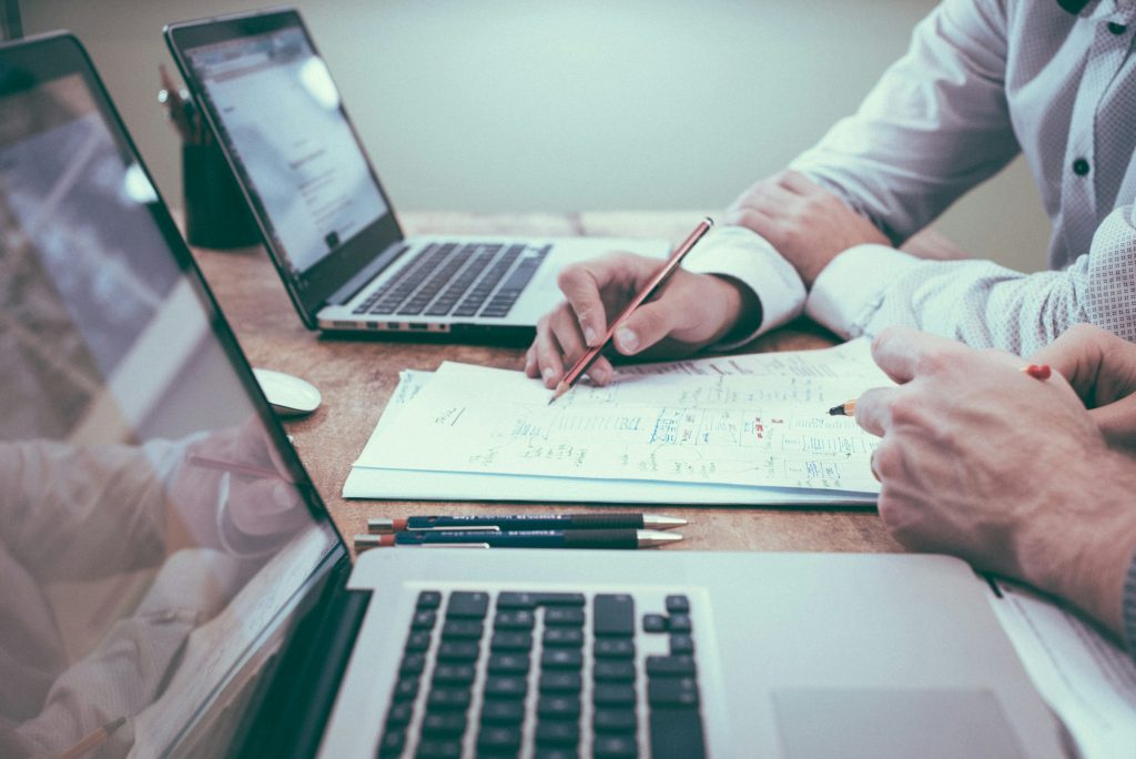 two people at a table with paperwork